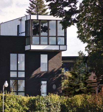 Exterior view of Echo House from distance surrounded by trees