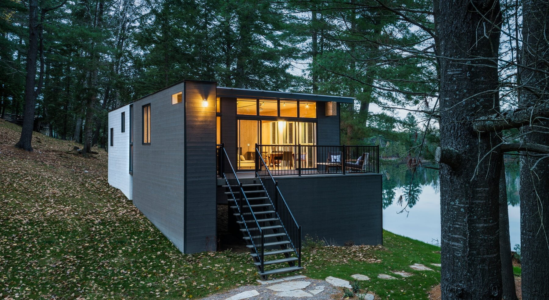 View of CLT Cottage exterior at front entry with view of lake
